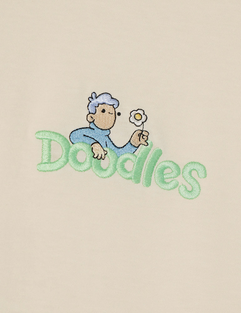 Marshmallow crewneck t-shirt with embroidered Hap design and Doodles logo, inspired by Dullsville and The Doodleverse. Logo close-up.